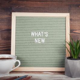 Board with letters that spell "What's new"